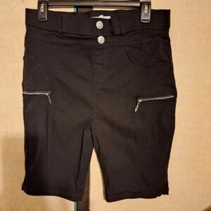 'Thrill Jeans' black cuffed shorts with zipper accents.